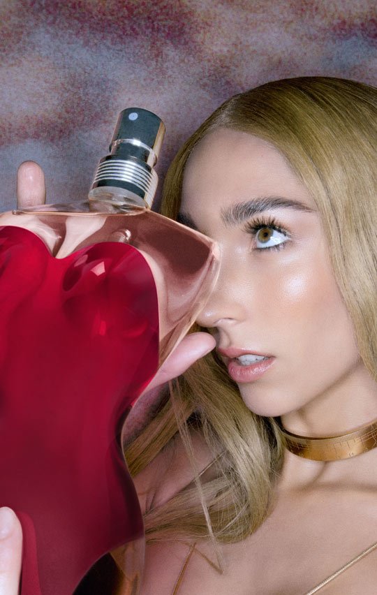 Our muse hiding behind the Classique fragrance bottle