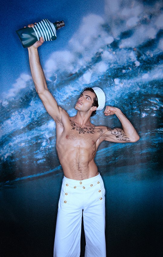 Le Male holding the fragrance in his hand